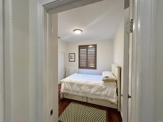 bedroom with dark hardwood / wood-style flooring