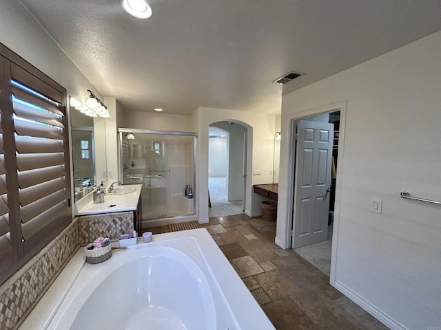 bathroom featuring vanity and shower with separate bathtub