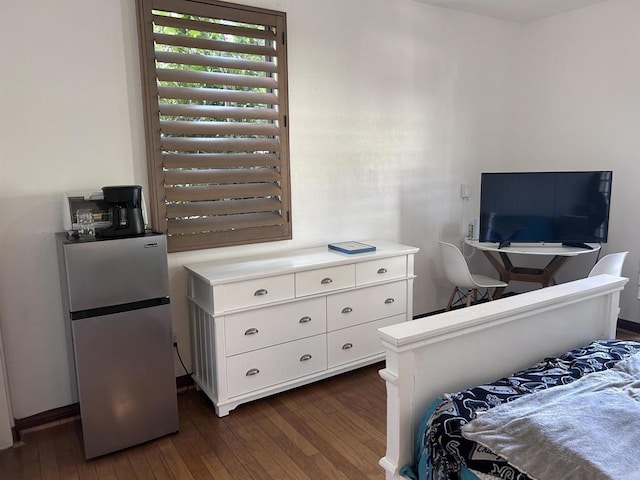 bedroom featuring dark wood-type flooring and stainless steel fridge