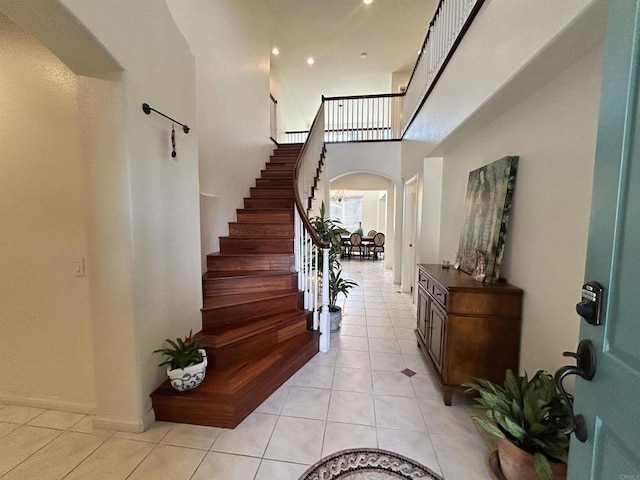 tiled foyer entrance with a high ceiling