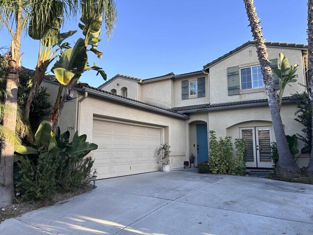 view of front of property with french doors and a garage