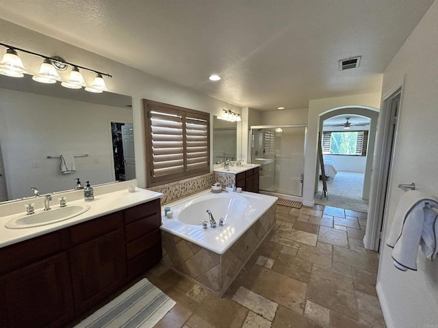 bathroom with ceiling fan, vanity, and separate shower and tub