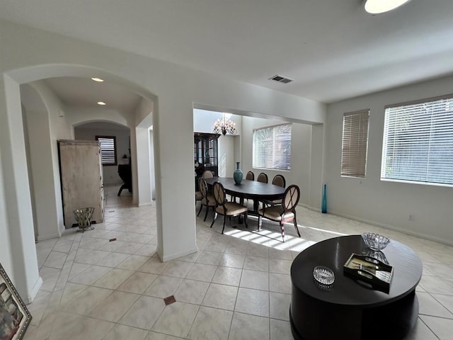 tiled dining area with a notable chandelier