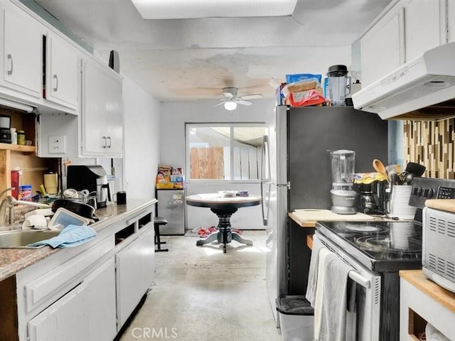 kitchen featuring ceiling fan, sink, electric range, and white cabinetry