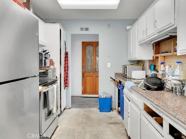 kitchen featuring stainless steel appliances and white cabinetry