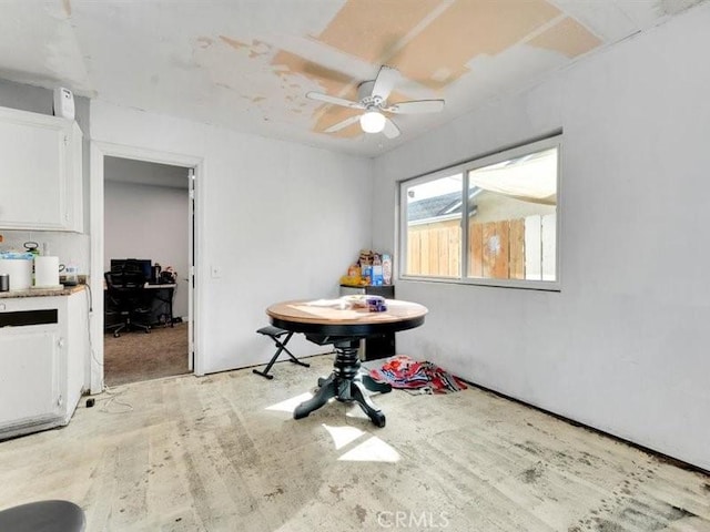 dining space with ceiling fan and light hardwood / wood-style flooring