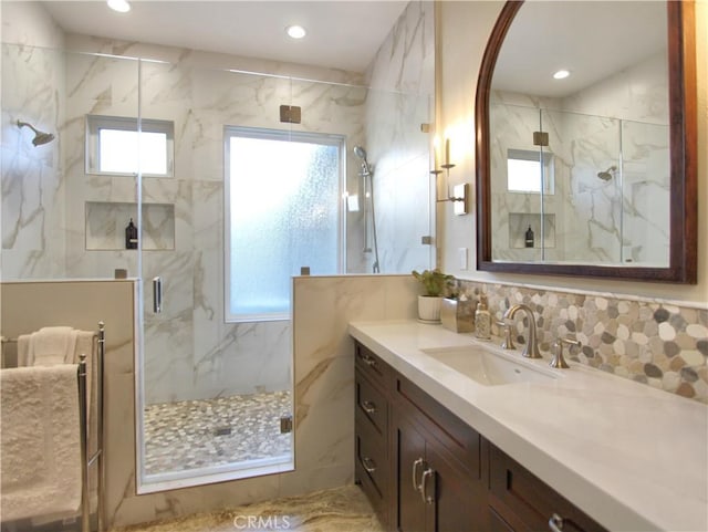 bathroom featuring vanity and a shower with shower door