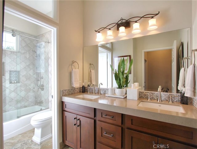 full bathroom featuring vanity, enclosed tub / shower combo, and toilet