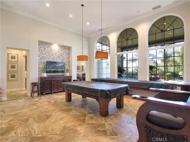 recreation room with plenty of natural light, ornamental molding, and billiards