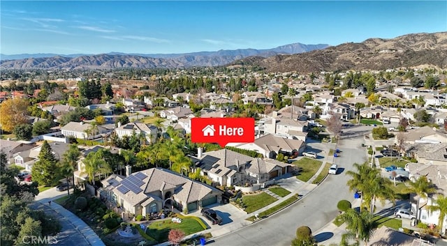 birds eye view of property with a mountain view