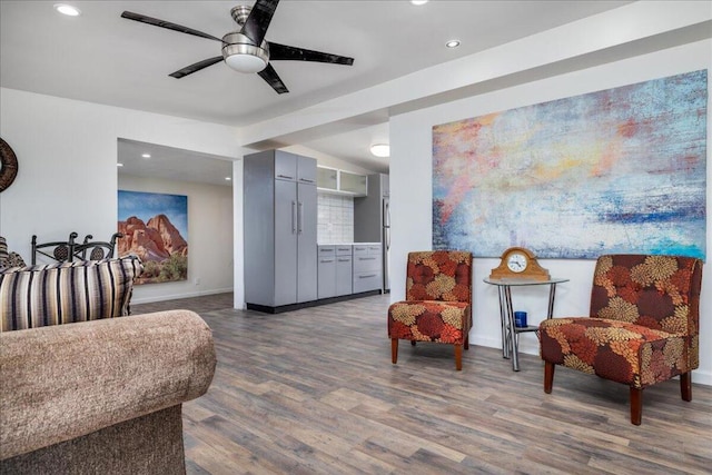 sitting room with ceiling fan and dark hardwood / wood-style floors