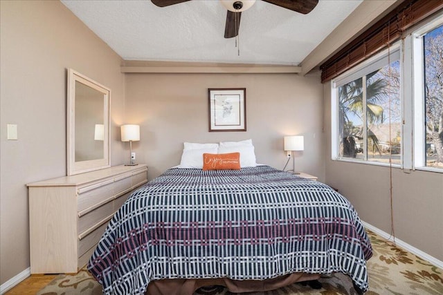 bedroom with ceiling fan and multiple windows