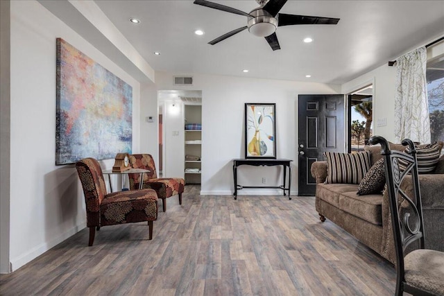 living room featuring hardwood / wood-style floors and ceiling fan