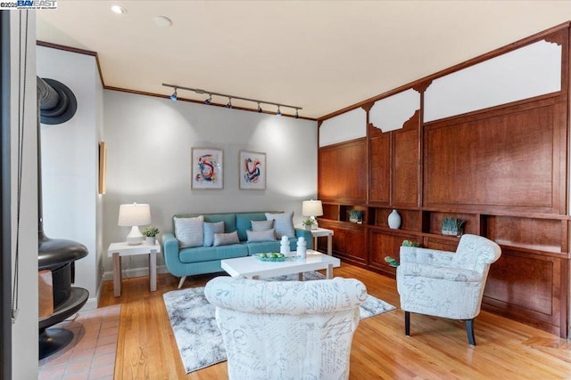 living room featuring crown molding and light hardwood / wood-style floors