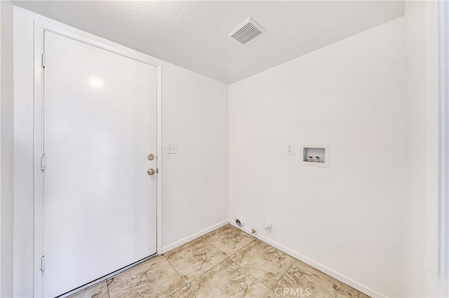 laundry area with hookup for a washing machine, a textured ceiling, and hookup for a gas dryer