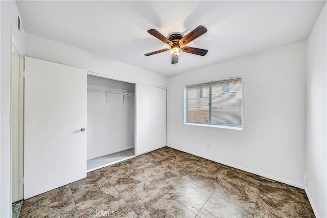 unfurnished bedroom with a ceiling fan, a closet, and baseboards