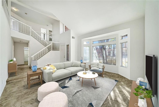 living area featuring marble finish floor, visible vents, a towering ceiling, baseboards, and stairs