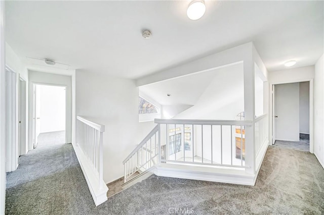 corridor featuring carpet floors and vaulted ceiling