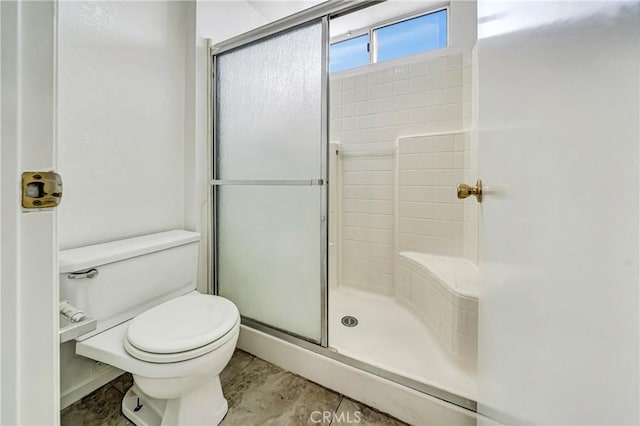 full bathroom with a shower stall and toilet