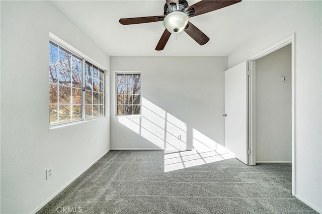 unfurnished room with ceiling fan, carpet flooring, and baseboards