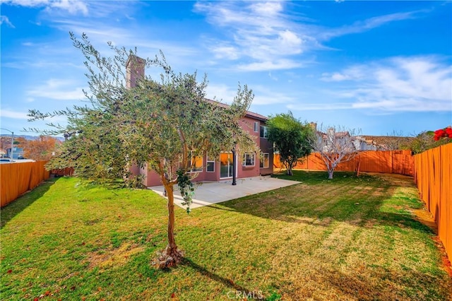 view of yard with a fenced backyard and a patio