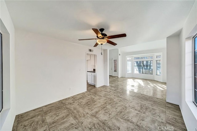 unfurnished living room with ceiling fan and visible vents