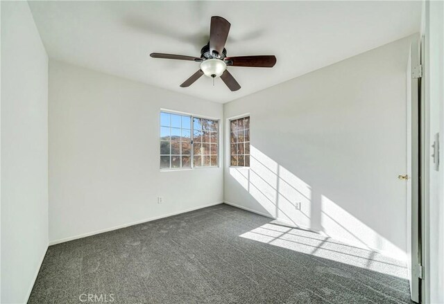 carpeted empty room featuring ceiling fan