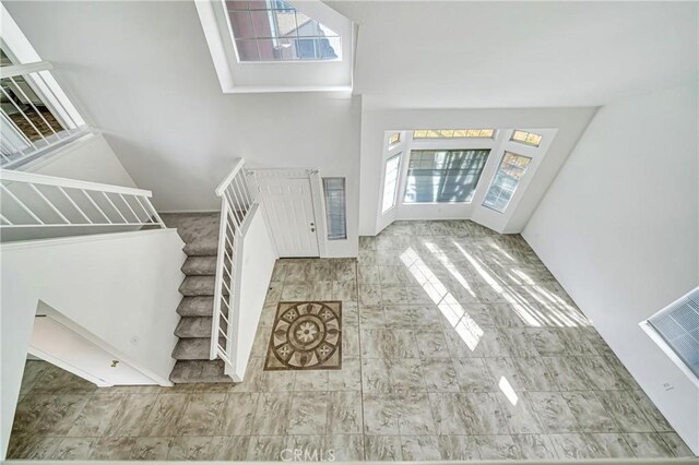 entryway featuring a towering ceiling