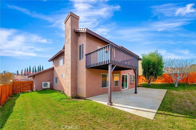 back of property with ac unit, a patio area, and a yard