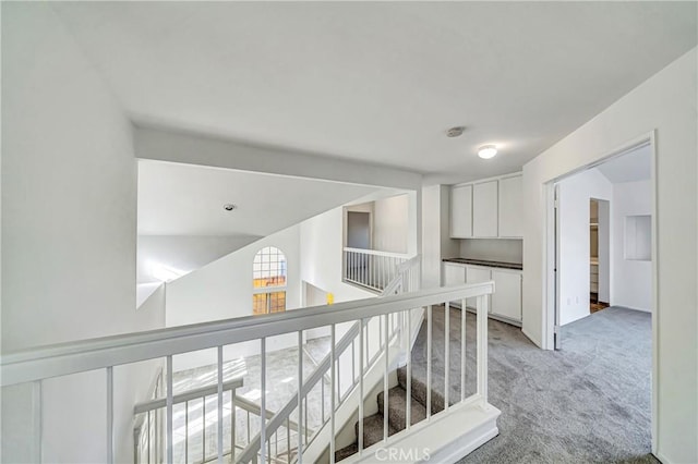 hallway with light colored carpet