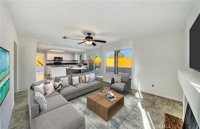 living area with visible vents and a ceiling fan