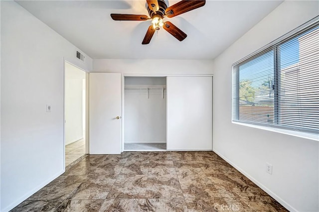 unfurnished bedroom with a closet, visible vents, ceiling fan, and baseboards