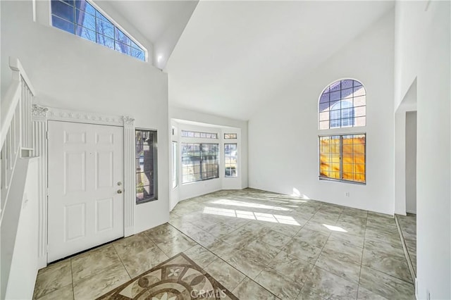 foyer with high vaulted ceiling