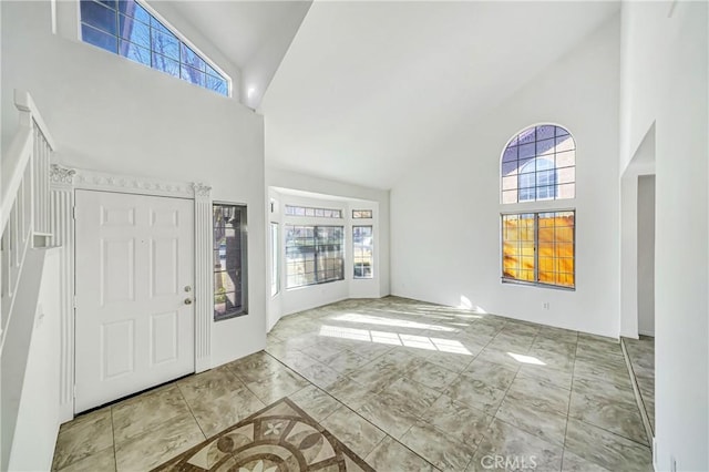 entryway with high vaulted ceiling and plenty of natural light