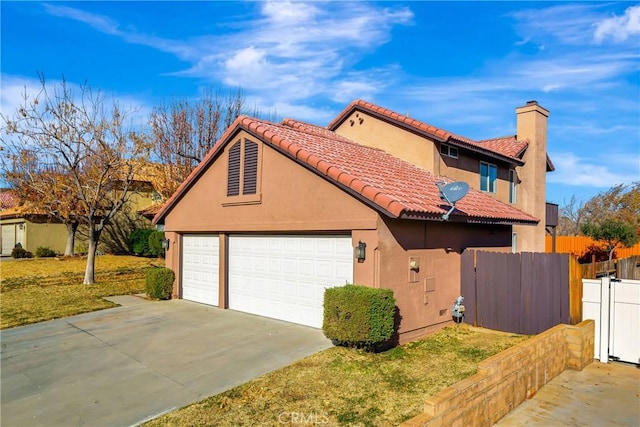 view of home's exterior featuring driveway, a tile roof, a chimney, fence, and stucco siding