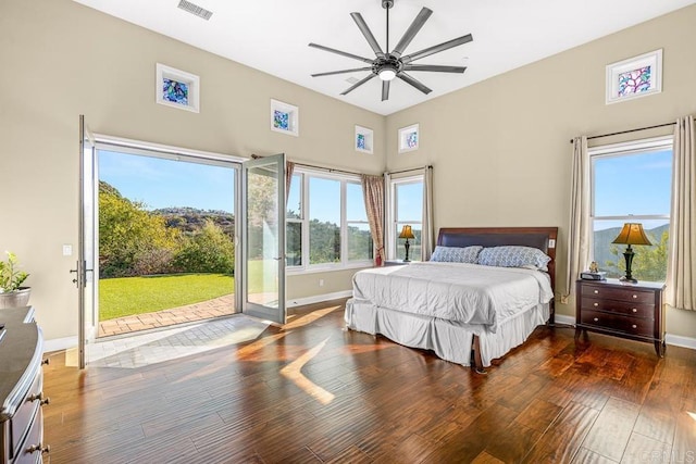 bedroom with ceiling fan, access to exterior, and dark hardwood / wood-style flooring