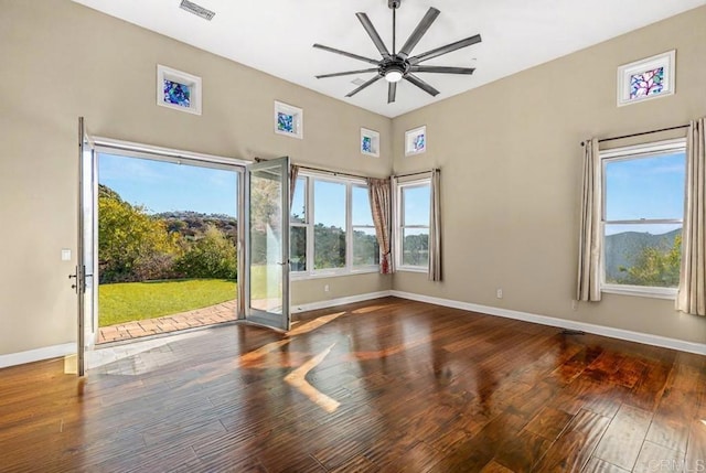 empty room featuring ceiling fan and dark hardwood / wood-style flooring