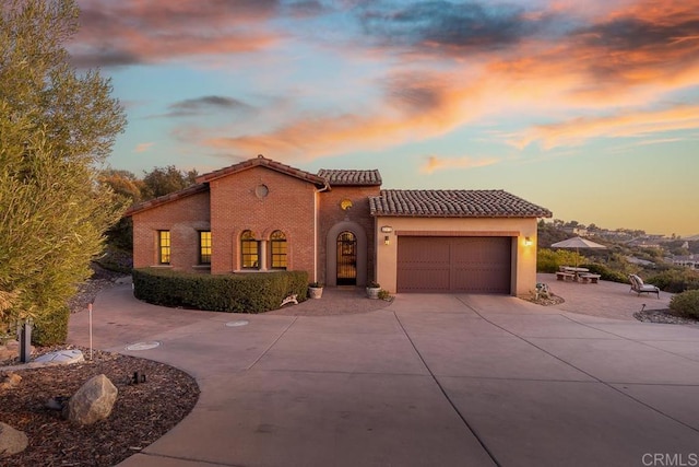 mediterranean / spanish-style home featuring a garage