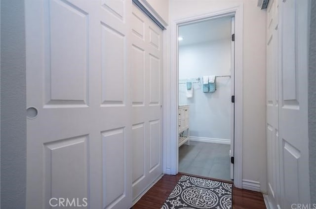 hall featuring dark wood finished floors and baseboards