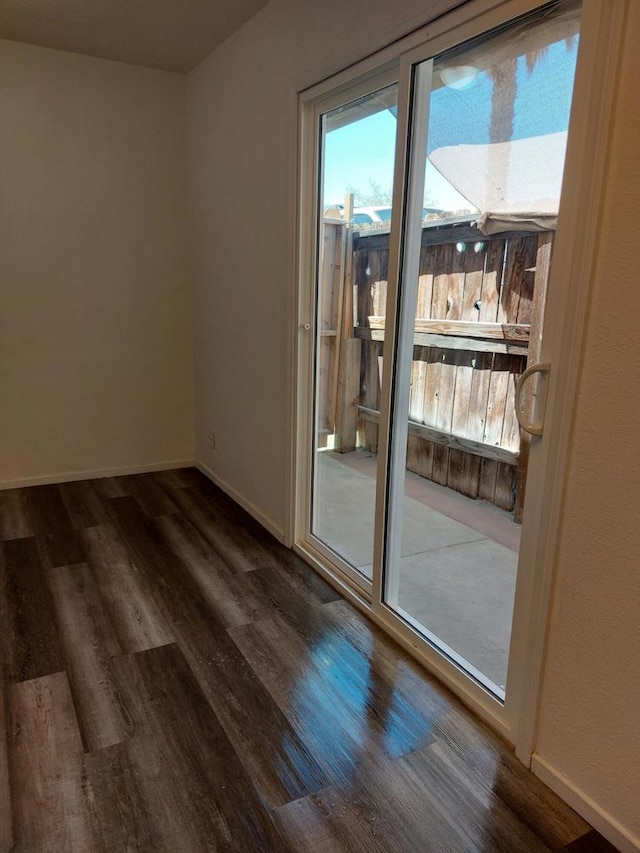 unfurnished room with dark wood-type flooring