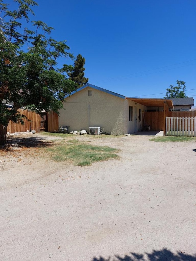 view of property exterior with a carport