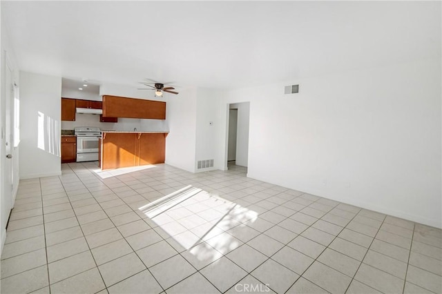 unfurnished living room with ceiling fan and light tile patterned flooring