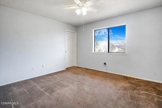 carpeted spare room featuring a textured ceiling and ceiling fan