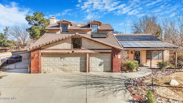 view of front facade featuring a garage and solar panels