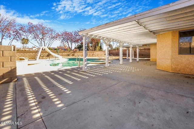 view of patio / terrace featuring a pergola and a fenced in pool