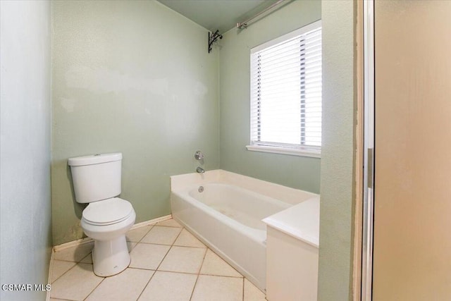 bathroom featuring tile patterned flooring, toilet, and a washtub