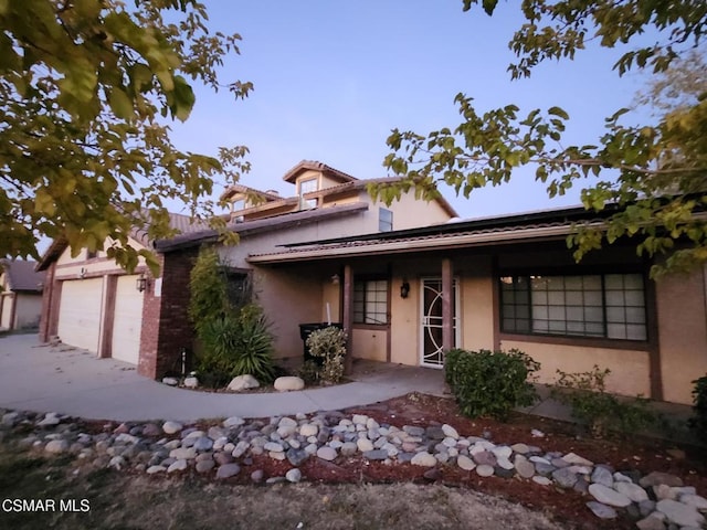 view of front of house featuring covered porch and a garage