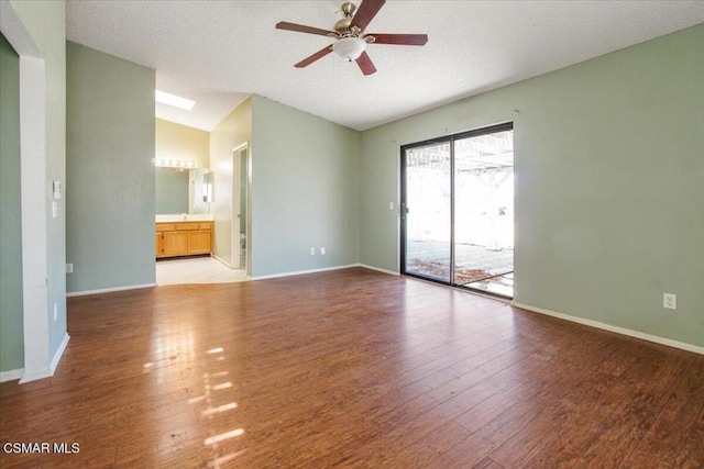 spare room with lofted ceiling, ceiling fan, a textured ceiling, and light wood-type flooring