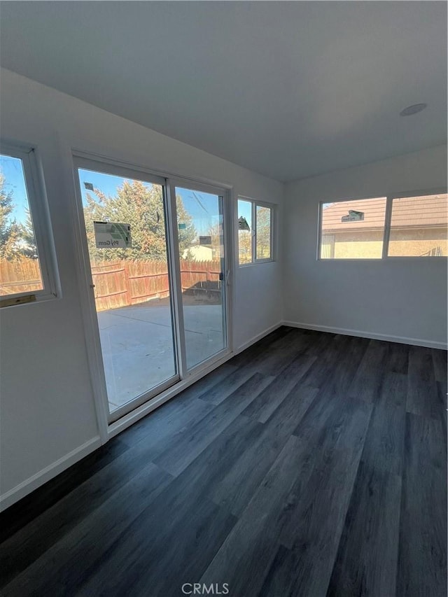 empty room with dark hardwood / wood-style flooring