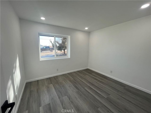 empty room with dark hardwood / wood-style flooring